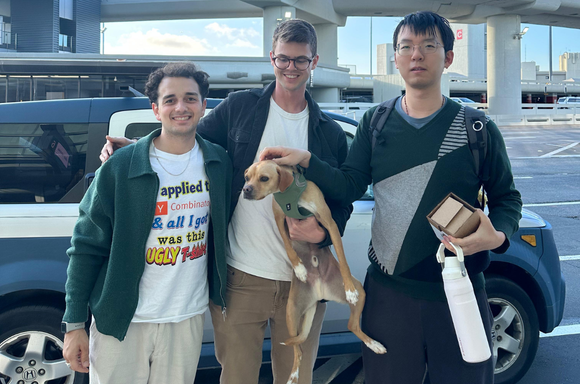 Three Convexity teammates together, one holding a dog